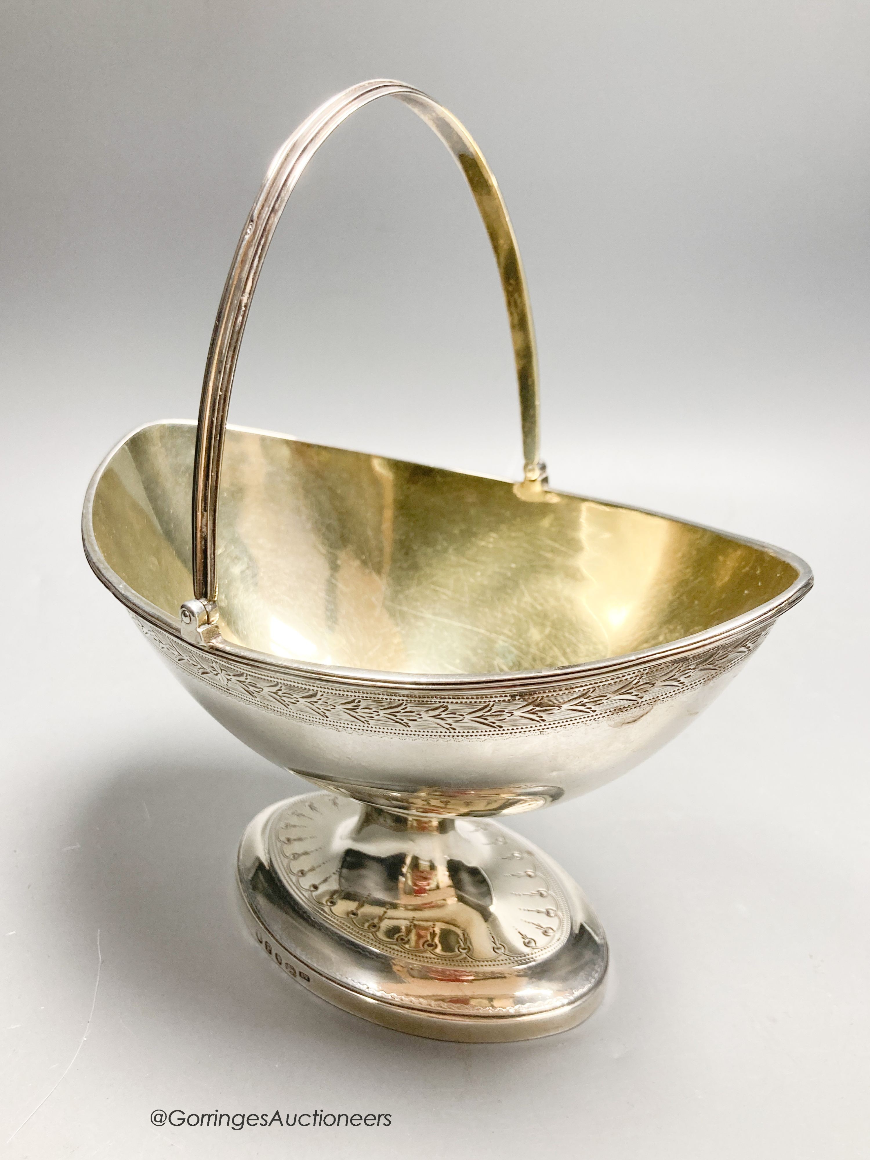 A George III silver boat shaped pedestal sugar basket, James Young, London, 1790, width 17.3cm, 10.5oz.